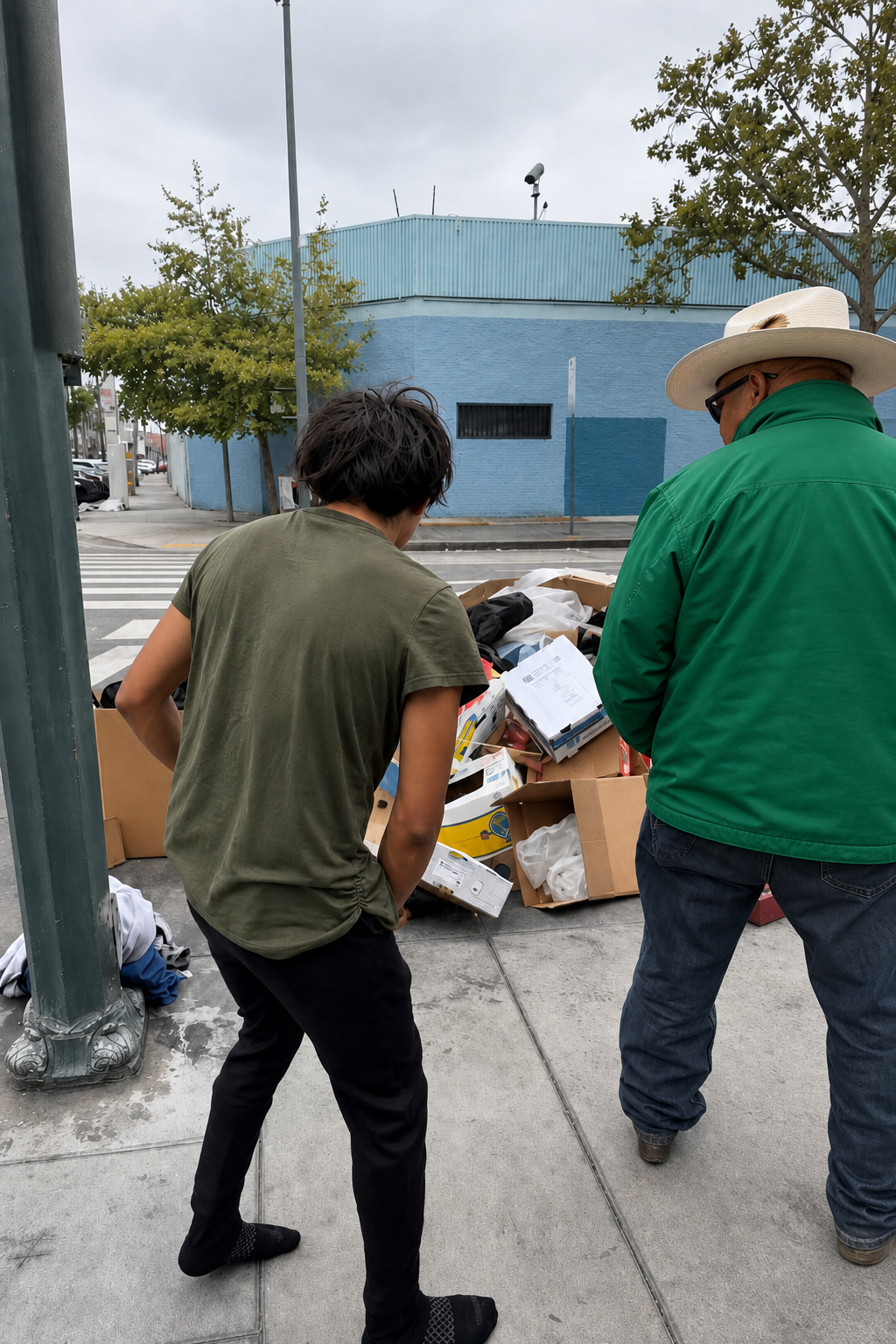 Empovia volunteer in green community jacket distributing clothing and supplies